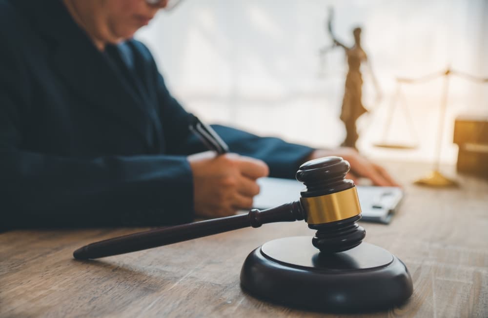 A judge's gavel, law enforcement officers, legal documents, and evidence are considered in a legal context.