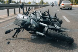 The motorcycle lies on the sidewalk after a ride. Serious accident. Accident, close-up.